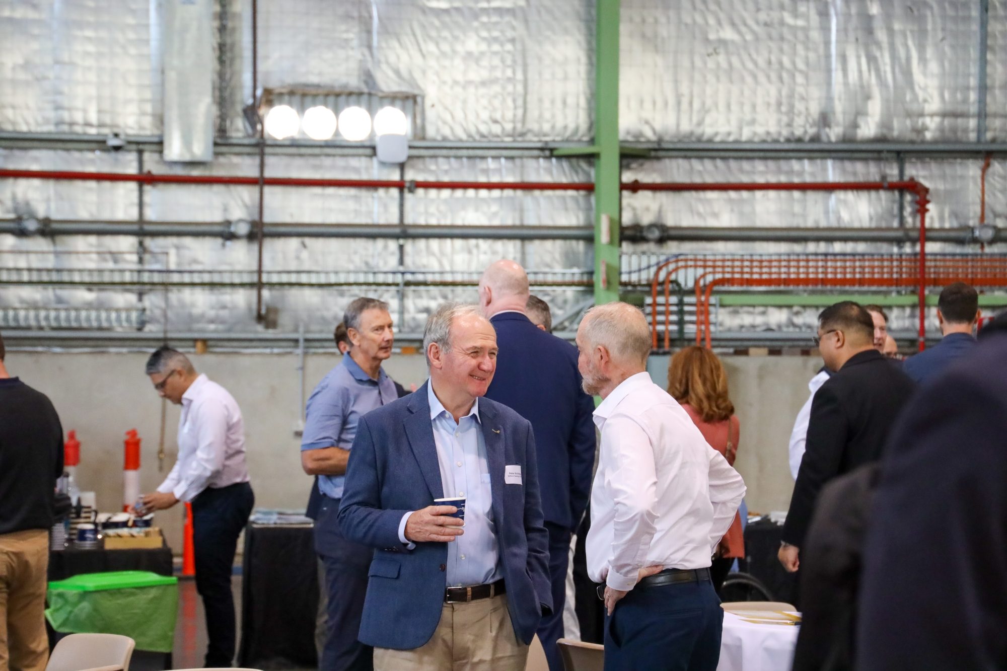 People chatting in industrial warehouse